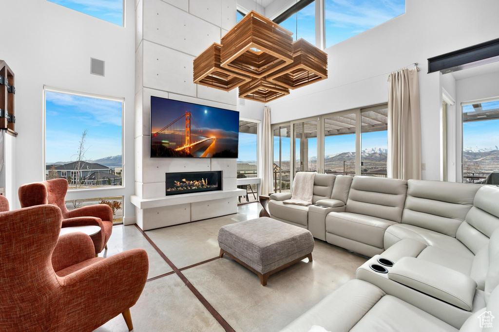 Living room with a high ceiling and a fireplace