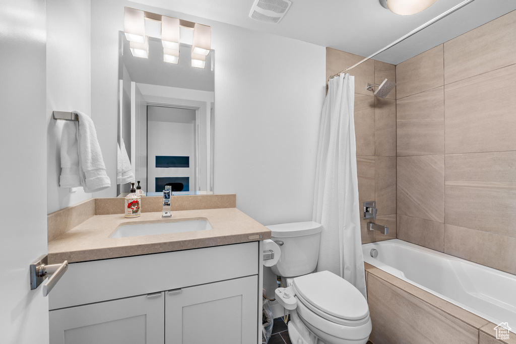 Full bath featuring vanity and shower / bath combo
