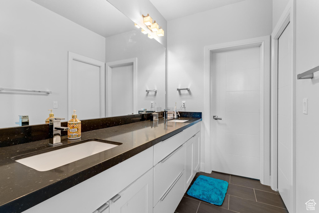 Full bath with double vanity and tile patterned floors