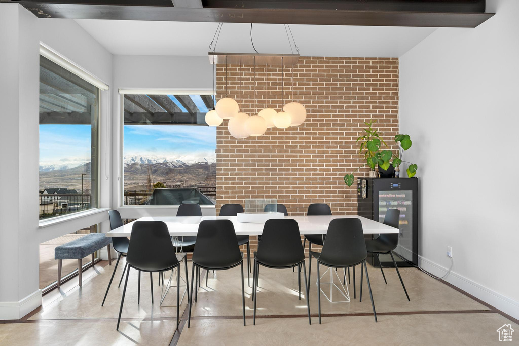 Dining space with brick wall and baseboards