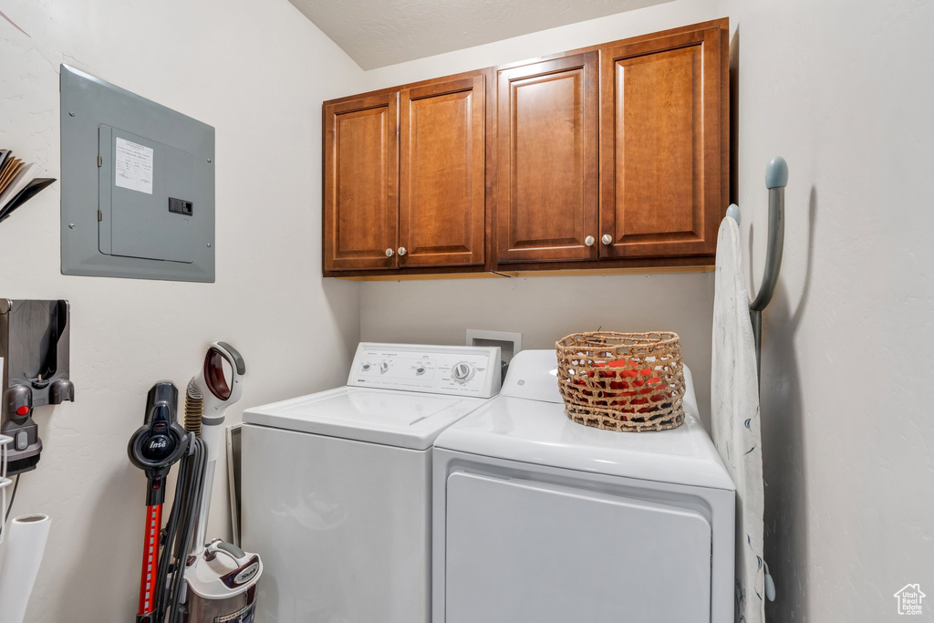 Laundry area with electric panel, washer and clothes dryer, and cabinet space