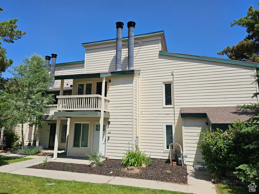 Back of house featuring a balcony