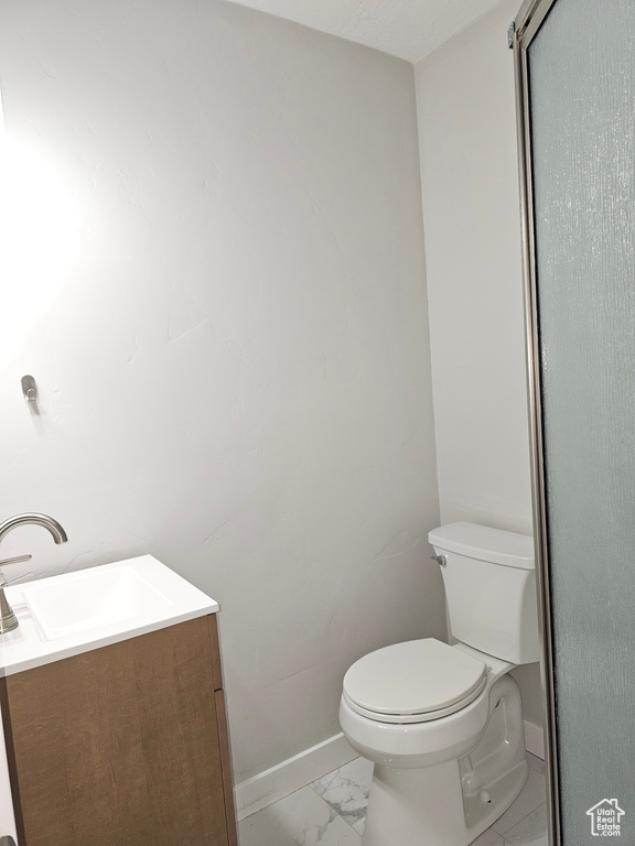 Bathroom with vanity and marble finish floors