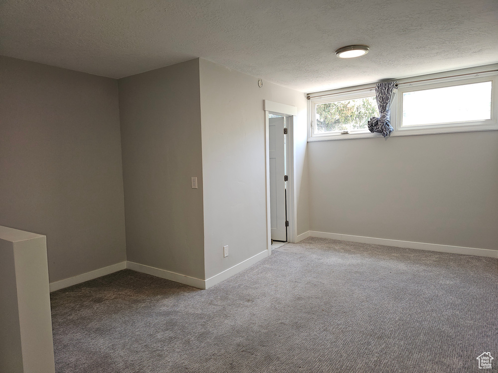 Spare room with a textured ceiling and carpet floors