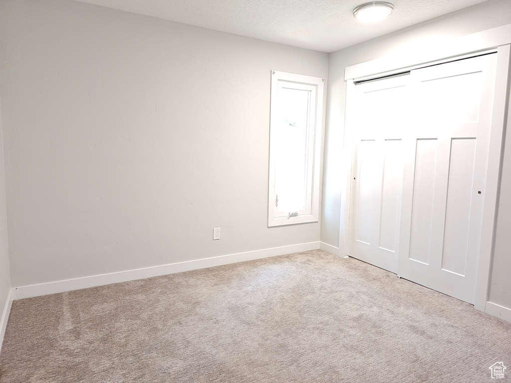 Unfurnished bedroom with carpet floors and a closet