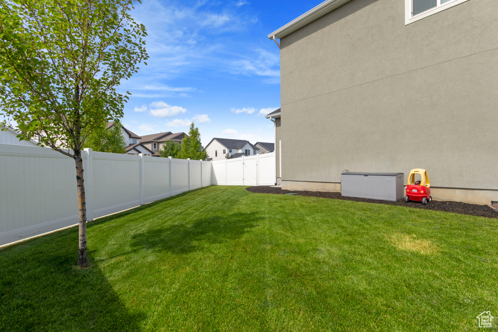 Fenced backyard featuring a residential view