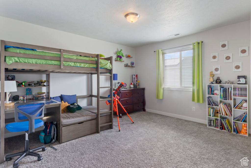 Bedroom featuring carpet flooring and baseboards