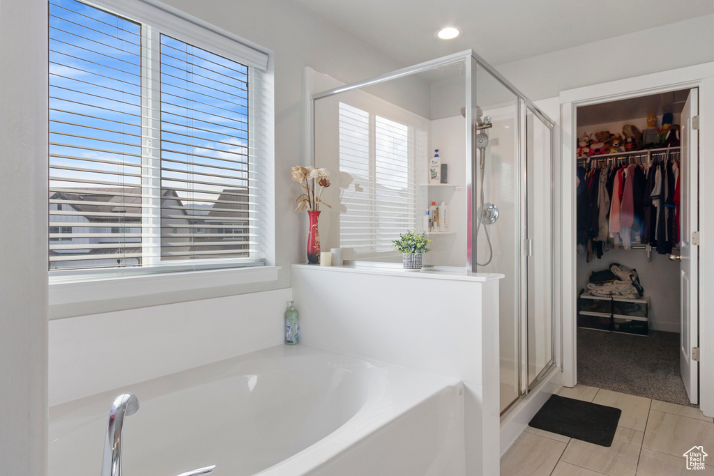 Full bathroom with a shower stall, a garden tub, a spacious closet, tile patterned flooring, and recessed lighting