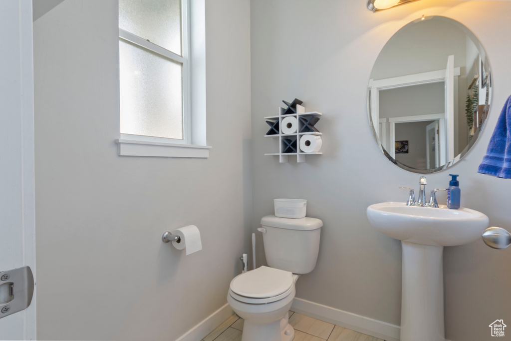 Bathroom with toilet and baseboards