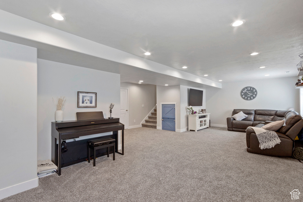Living room featuring carpet flooring, recessed lighting, and stairway