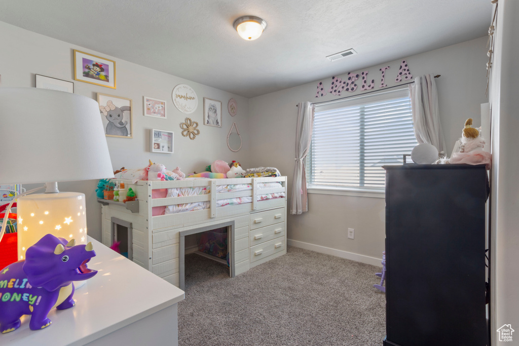Bedroom featuring carpet flooring and baseboards