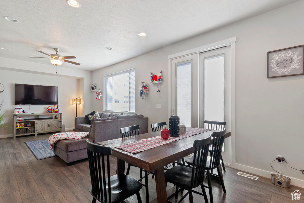 Dining area featuring dark wood-type flooring, recessed lighting, and ceiling fan
