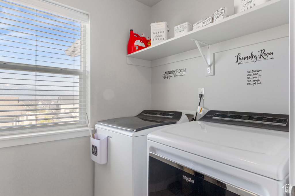 Laundry area featuring washing machine and dryer and plenty of natural light