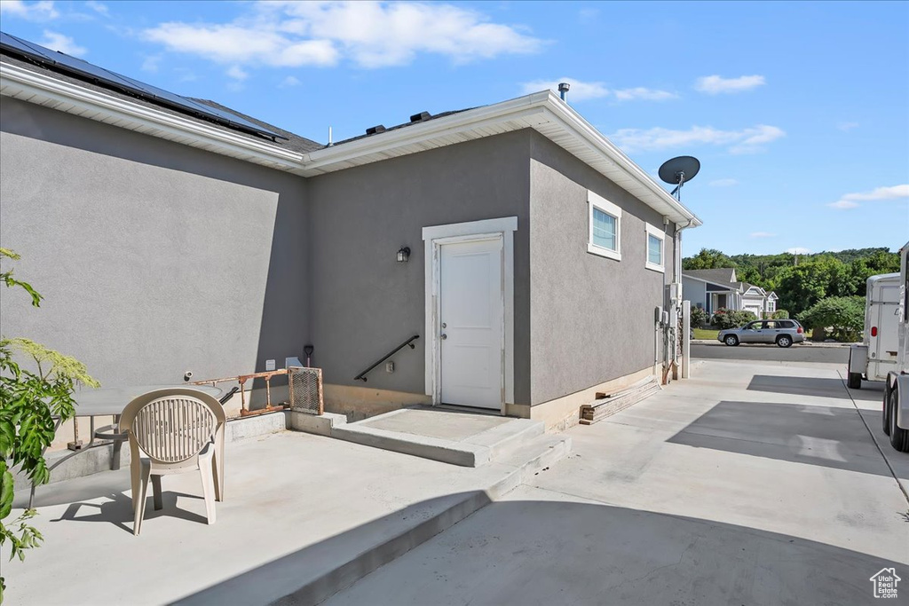 Entrance to property with a patio area and stucco siding