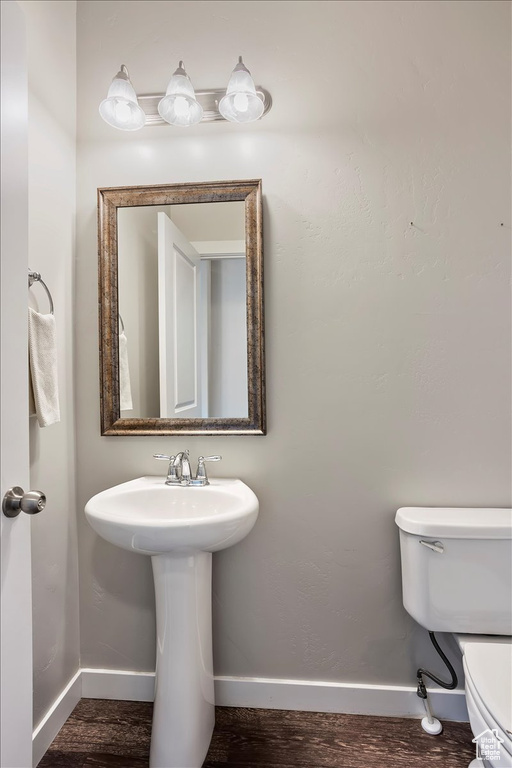 Half bathroom featuring wood finished floors