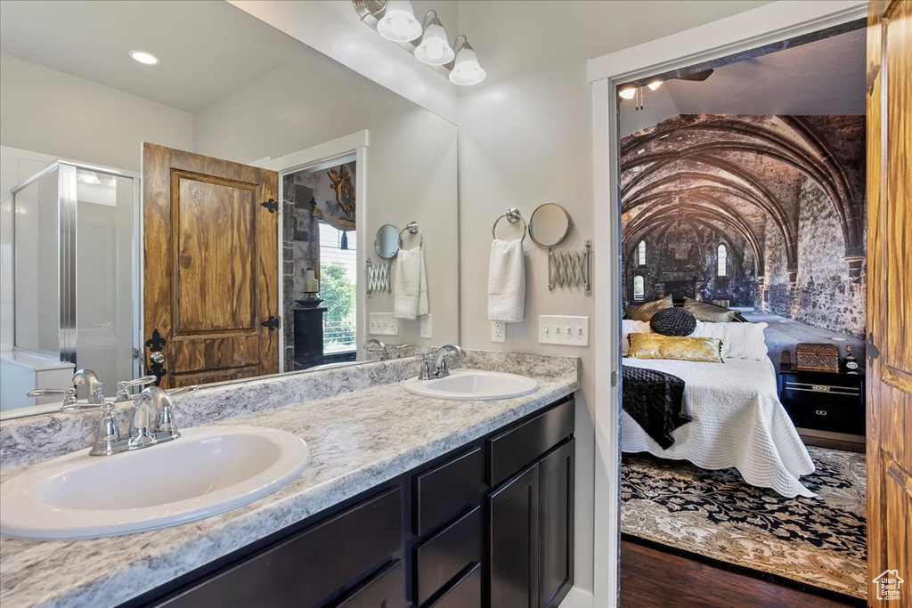Ensuite bathroom featuring double vanity and a stall shower