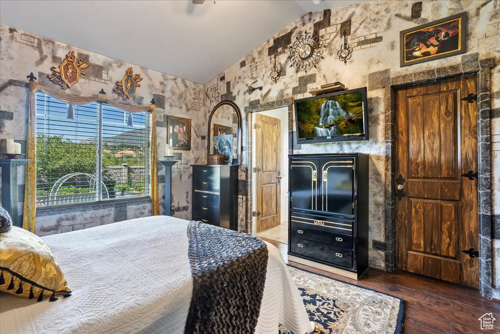 Bedroom featuring vaulted ceiling and hardwood / wood-style flooring