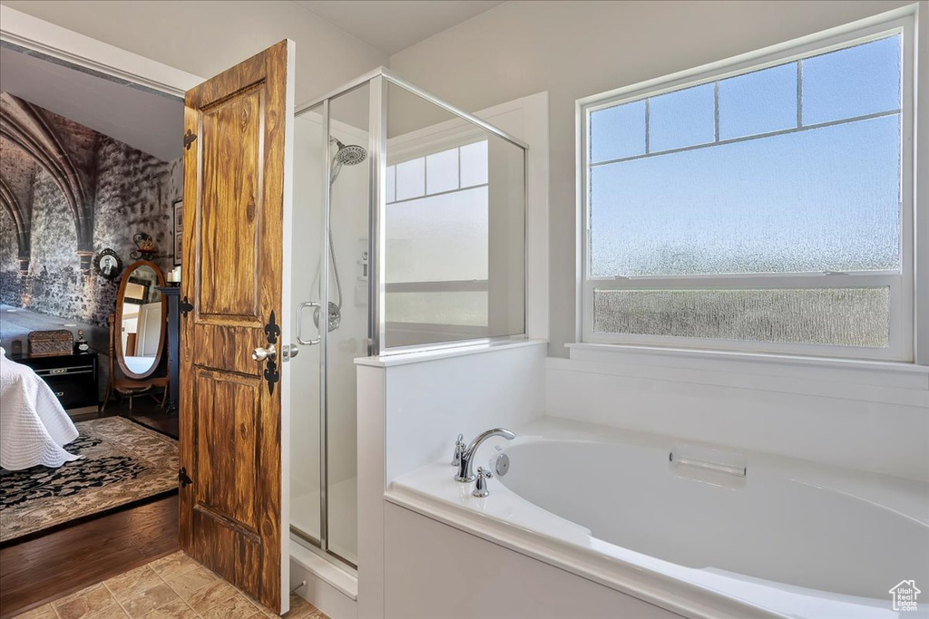 Full bathroom with a stall shower, a garden tub, and ensuite bath