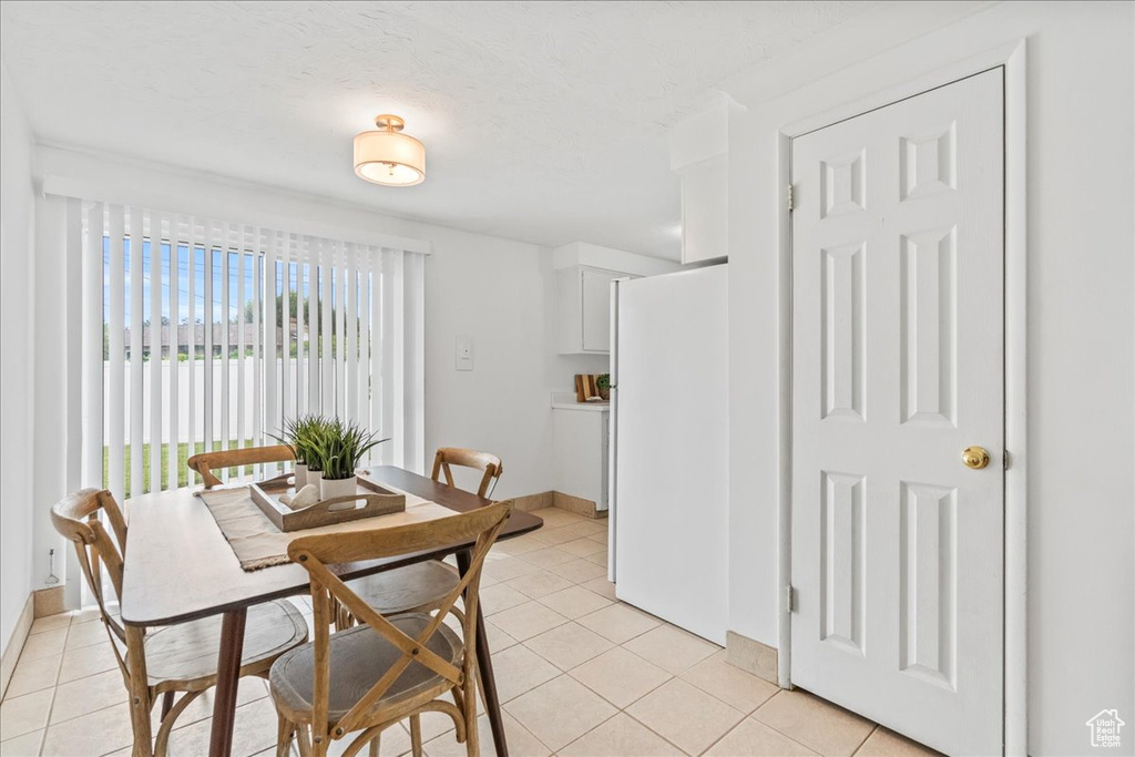 Dining room featuring light tile patterned floors and baseboards