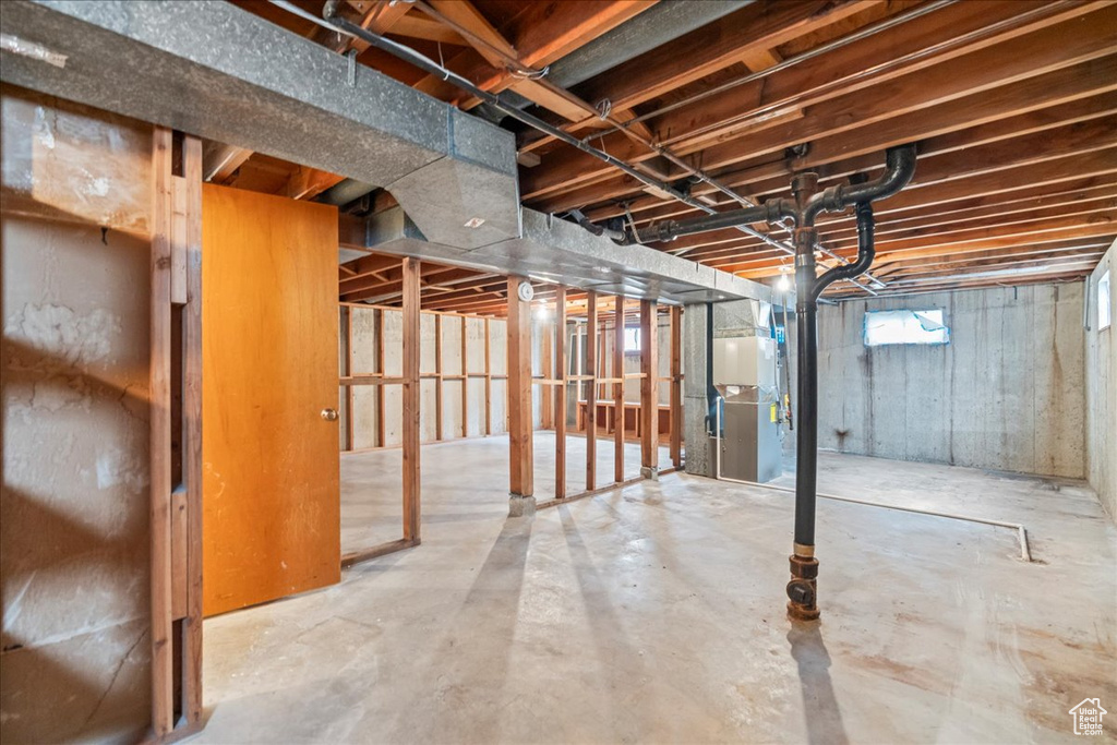 Basement featuring heating unit