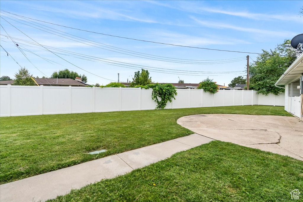 Fenced backyard with a patio