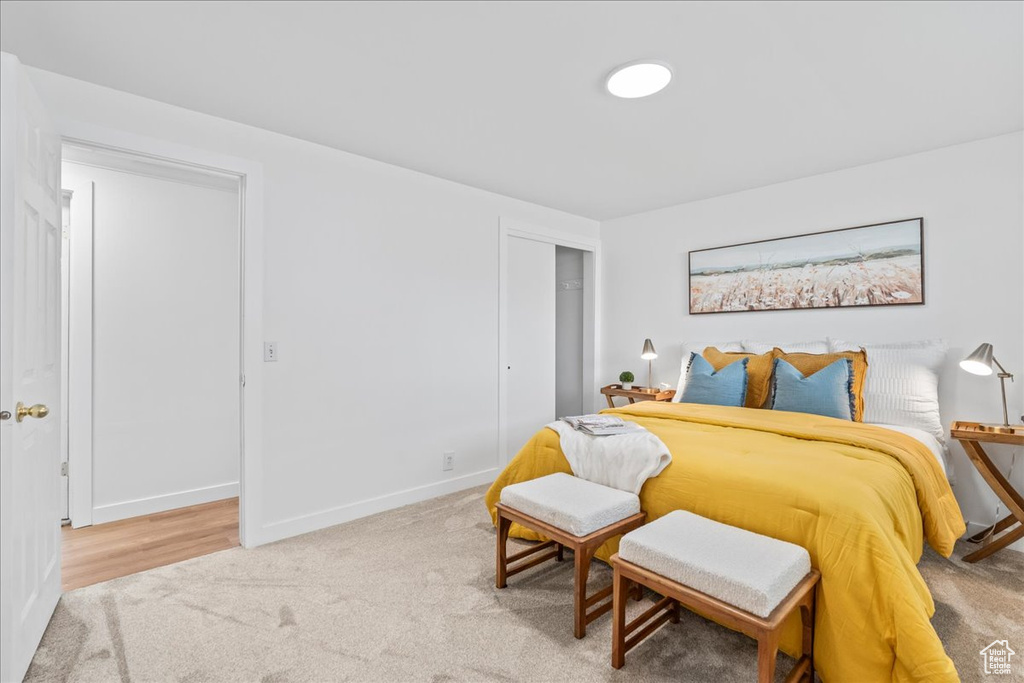 Carpeted bedroom featuring a closet and baseboards