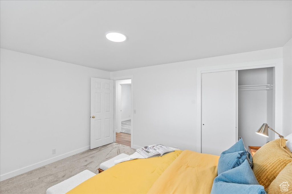 Bedroom featuring a closet and light colored carpet