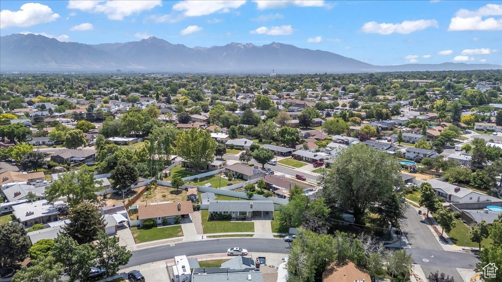 Aerial overview of property\'s location featuring a mountainous background and nearby suburban area