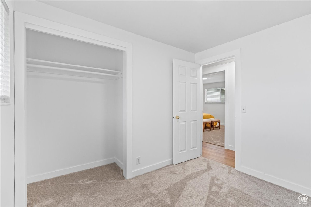 Unfurnished bedroom featuring carpet flooring and a closet