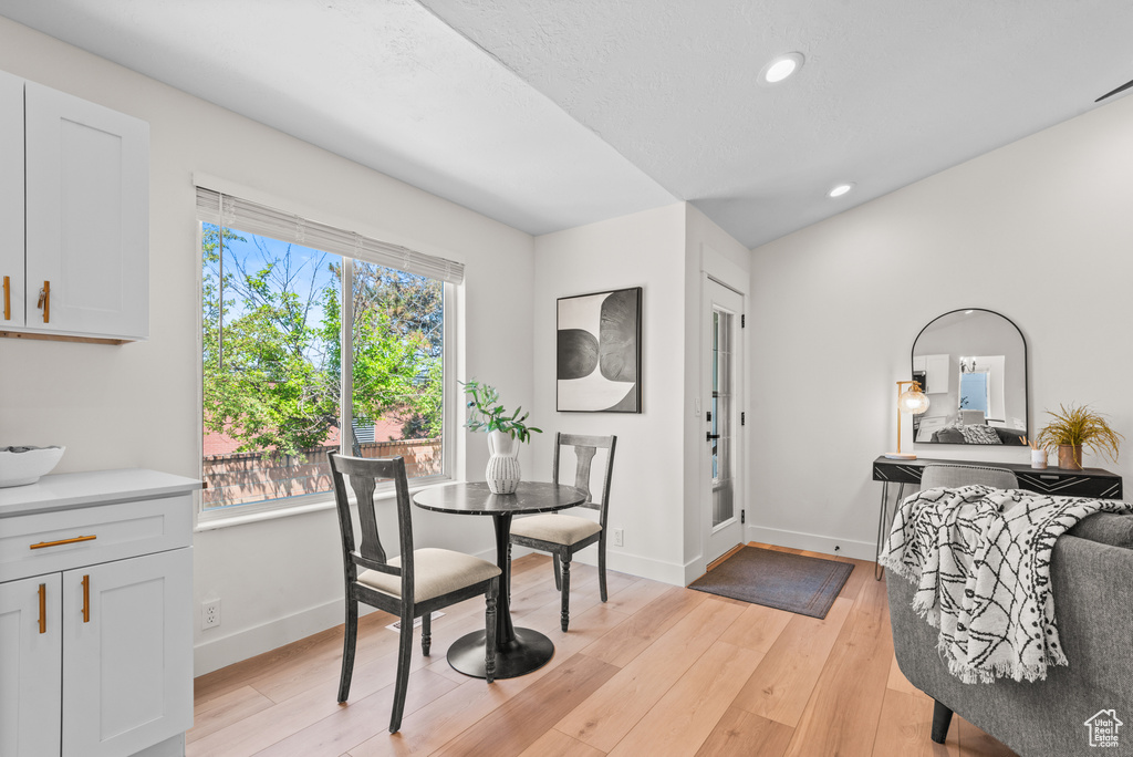 Dining room with plenty of natural light, light wood-style flooring, and recessed lighting