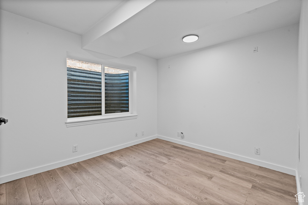 Empty room featuring wood finished floors and baseboards