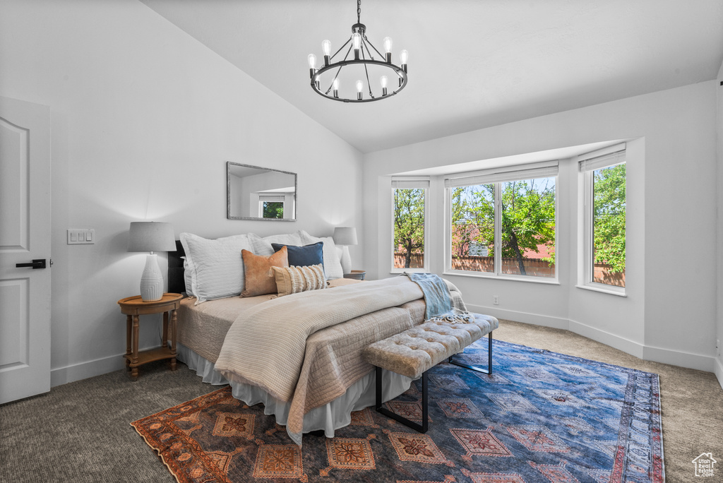 Carpeted bedroom with multiple windows, a chandelier, and high vaulted ceiling