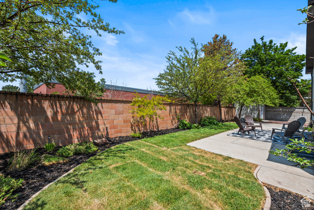 Fenced backyard featuring a patio area