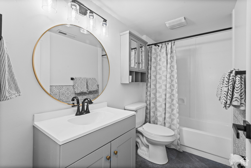 Bathroom featuring vanity and shower / bath combination with curtain