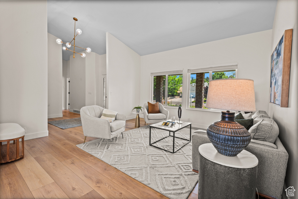 Living area featuring wood finished floors and a chandelier