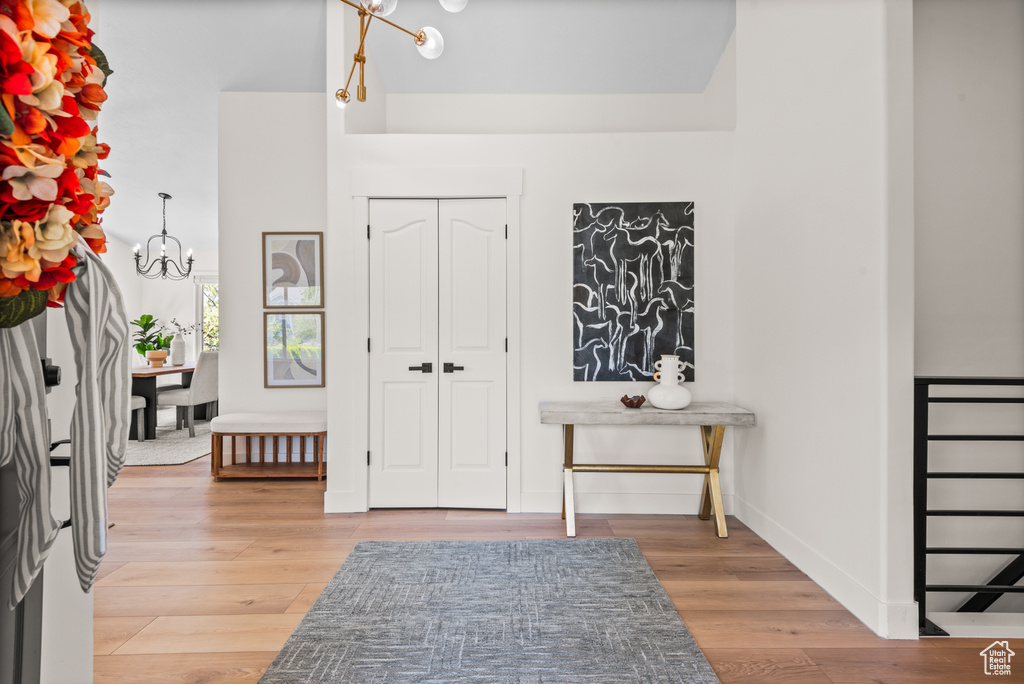 Foyer with a chandelier and light wood-style flooring