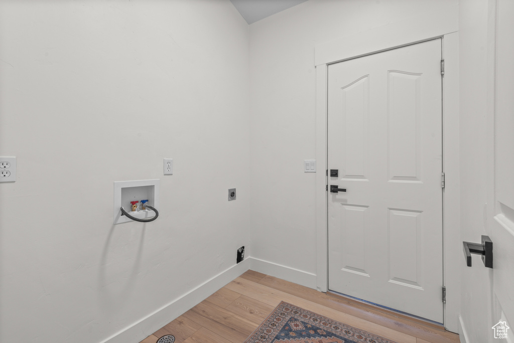 Laundry room featuring electric dryer hookup, light wood finished floors, and hookup for a washing machine