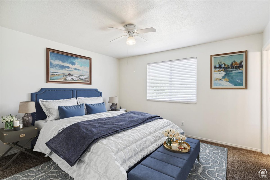 Carpeted bedroom with baseboards and ceiling fan