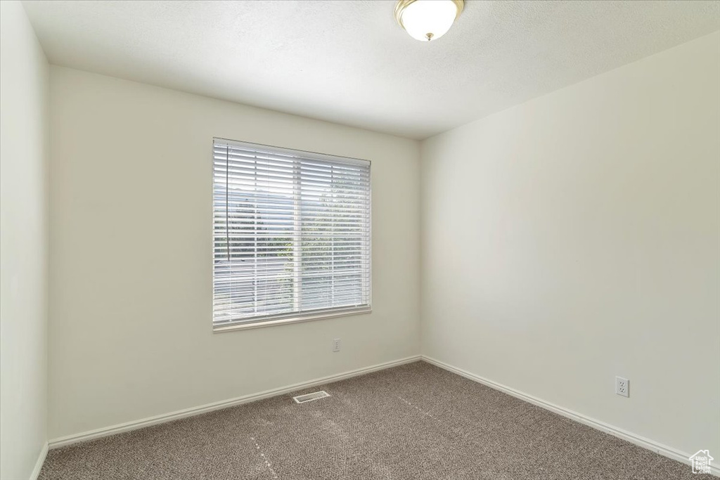 Unfurnished room with carpet floors and baseboards