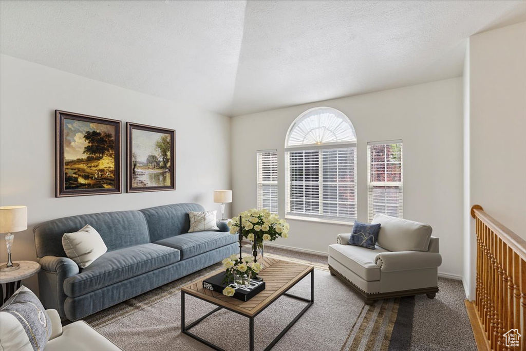 Carpeted living area featuring baseboards