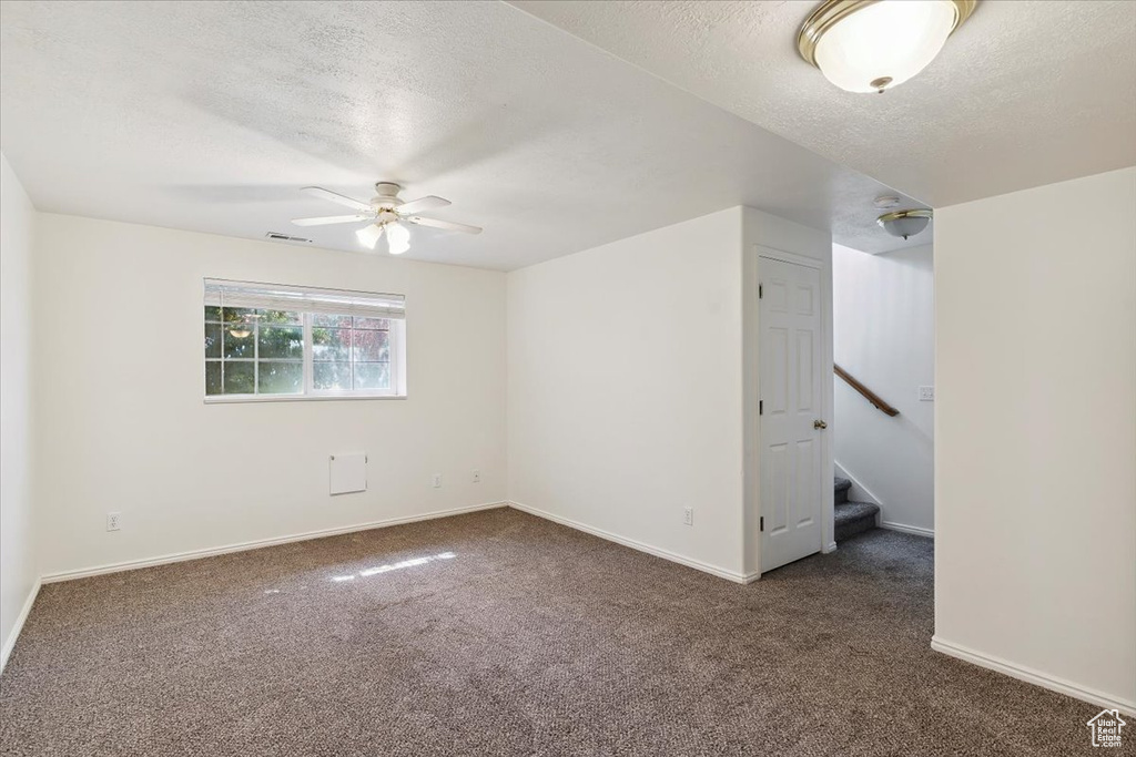 Unfurnished bedroom featuring carpet and a textured ceiling
