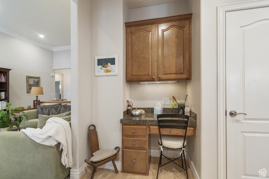 Office space featuring ornamental molding and light wood finished floors