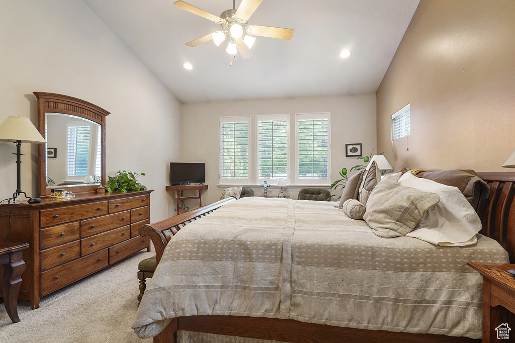 Bedroom with multiple windows, light colored carpet, recessed lighting, ceiling fan, and high vaulted ceiling