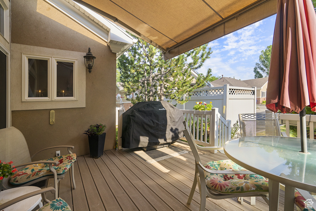 Deck with a grill and outdoor dining space