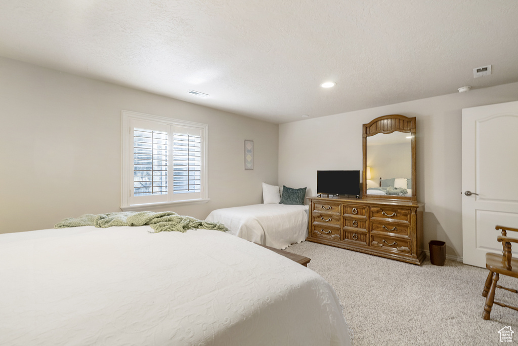 Bedroom with carpet floors and recessed lighting