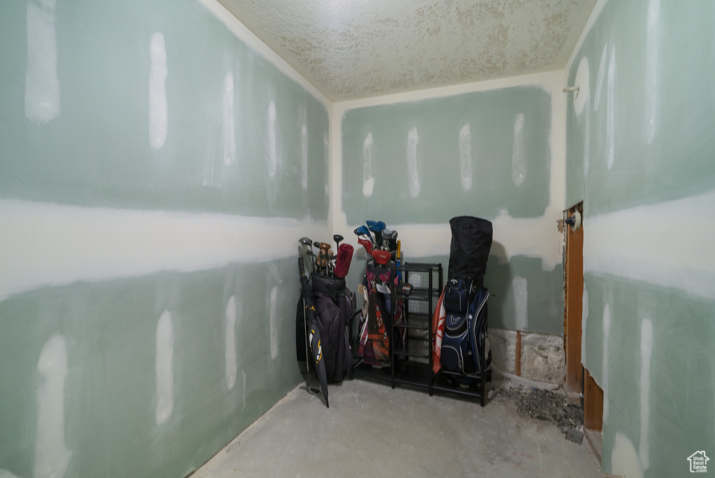 Misc room with unfinished concrete flooring