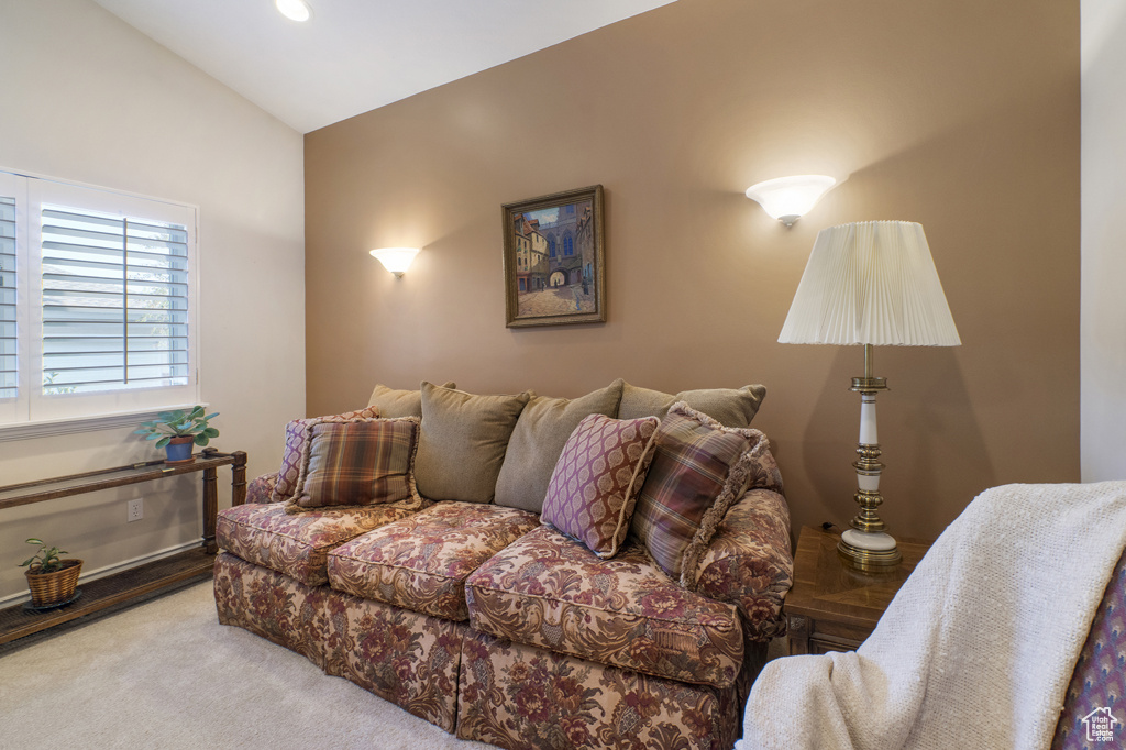 Carpeted living room featuring vaulted ceiling and recessed lighting