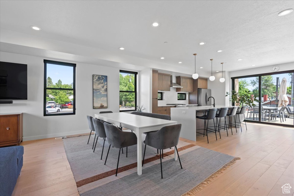 Dining space with light wood-style flooring and recessed lighting