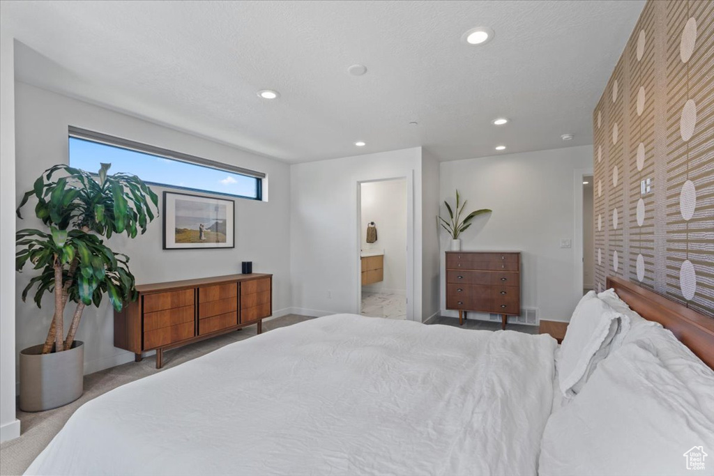Bedroom featuring recessed lighting, ensuite bathroom, and carpet