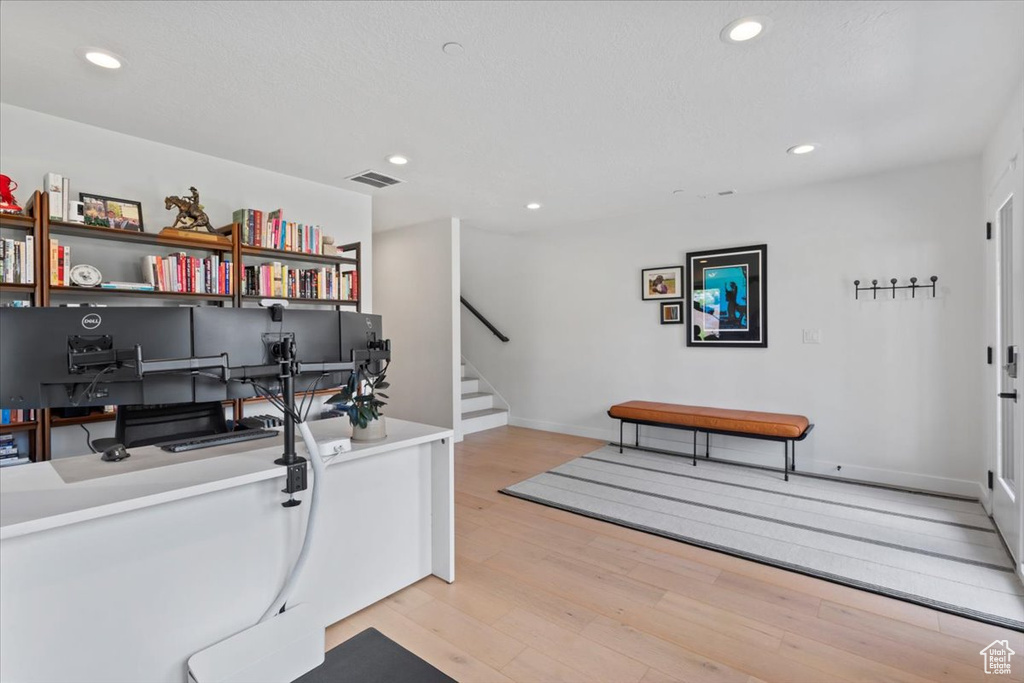 Home office featuring light wood-style flooring and recessed lighting